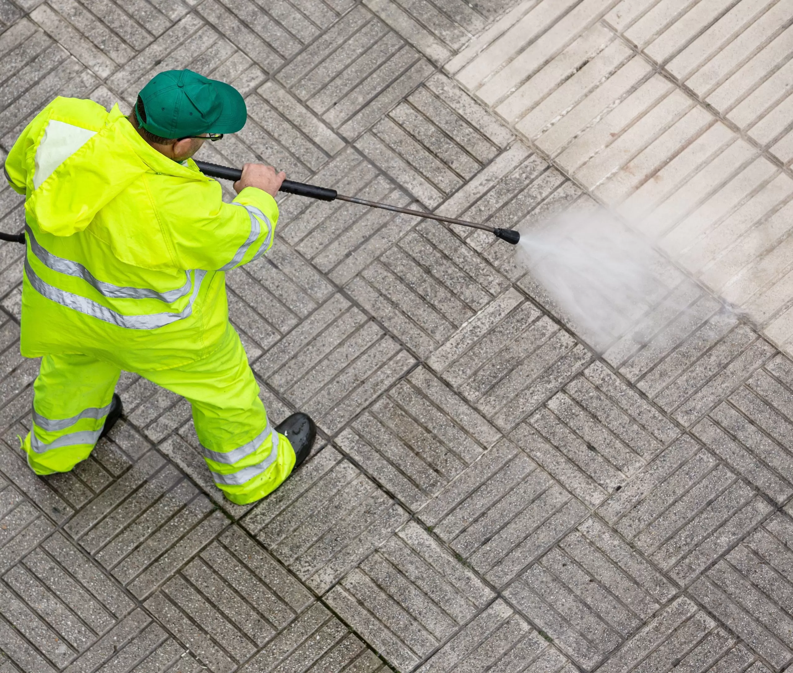 worker-cleaning-pavement-sidewalk-with-high-pressure-water jet